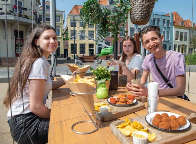 Students eating and chatting at the Bellamy park in Vlissingen