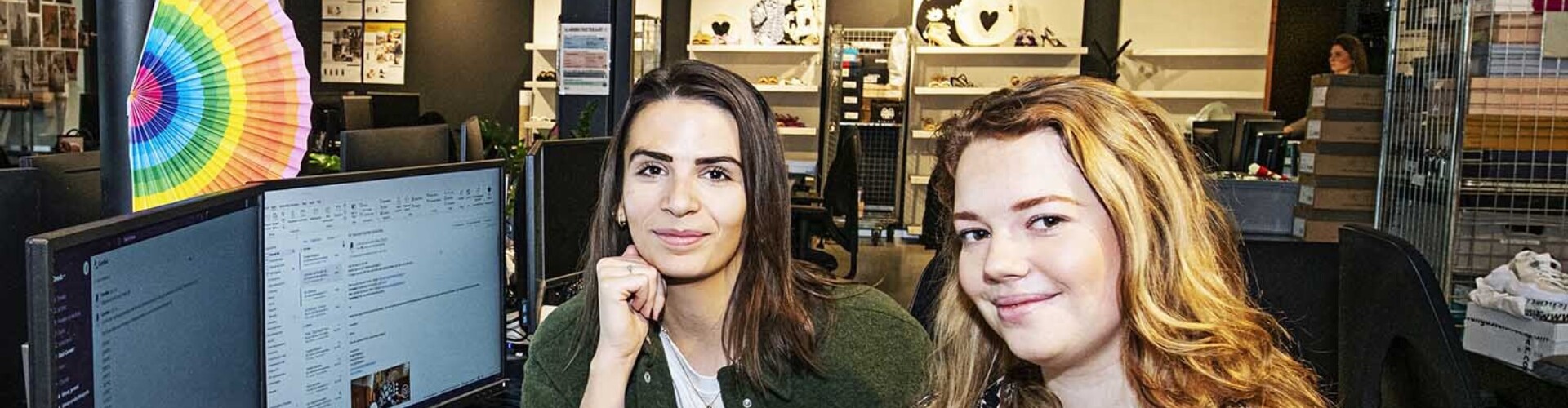 Twee Communicatie studenten zitten samen aan een bureau