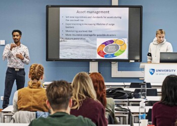 A teacher presenting in front of a class of students
