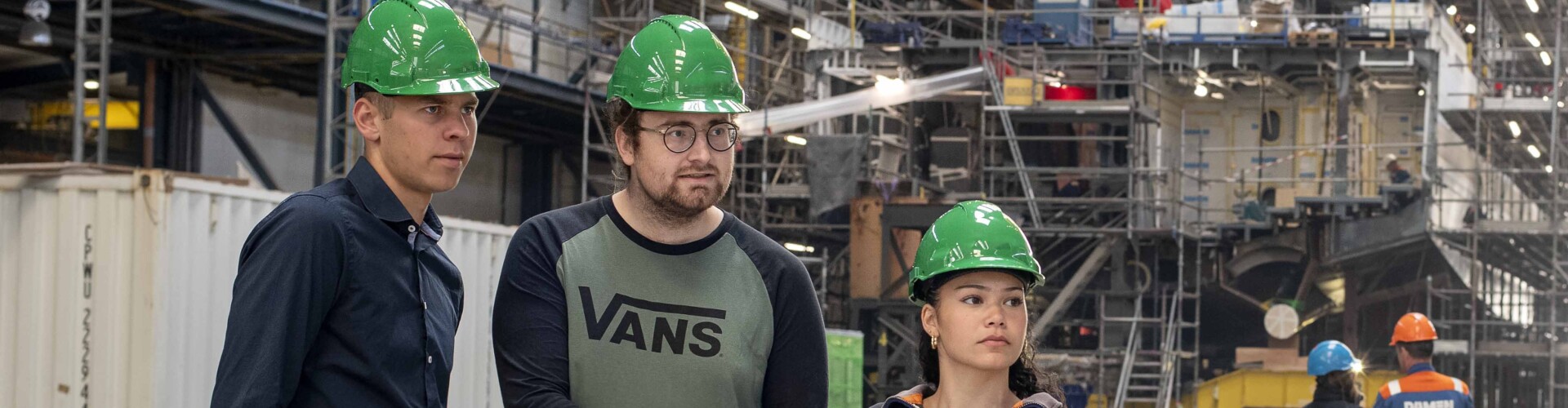 Three Industrial Engineering and Management students looking at something