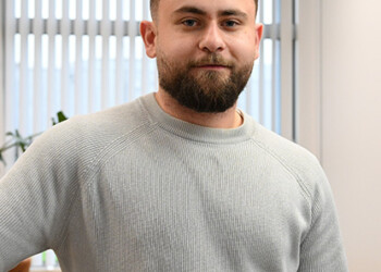 Former HZ student Hasan is posing at his office at Lamb Weston