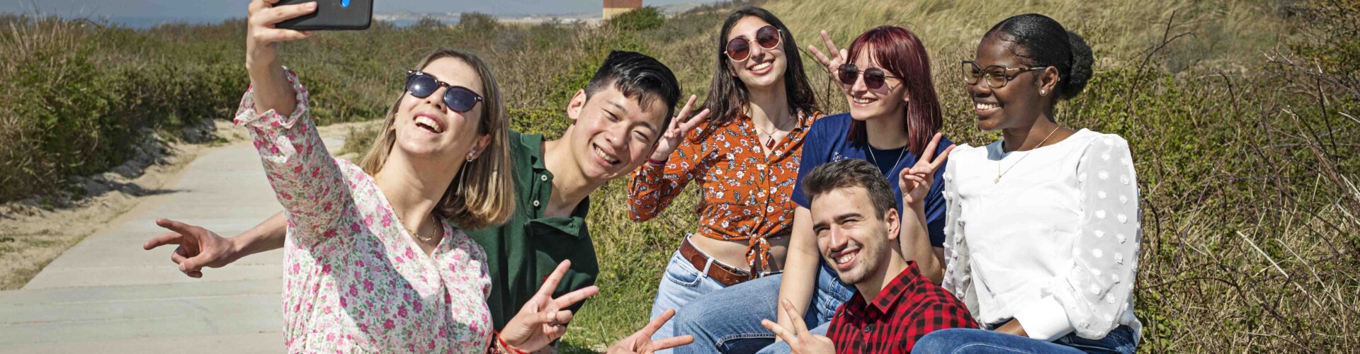 Students taking a selfie together in the dunes of Zeeland