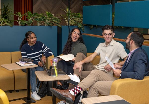 Students having a conversation with a teacher