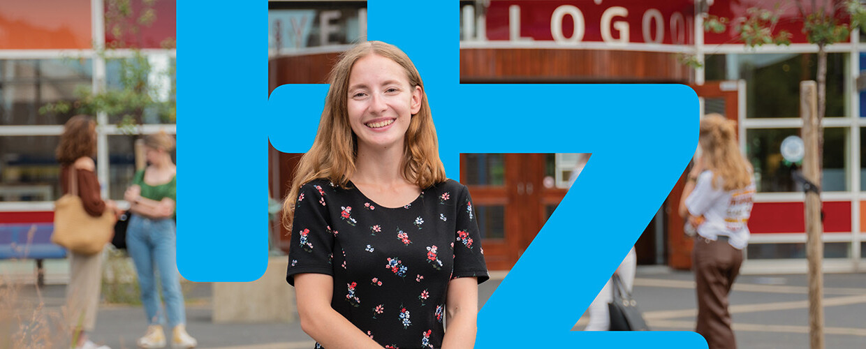 Student in front of HZ building with logo HZ