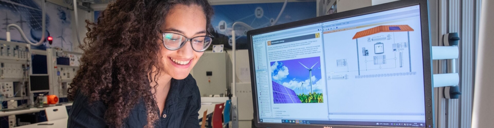 Researcher with small solar panel at a screen