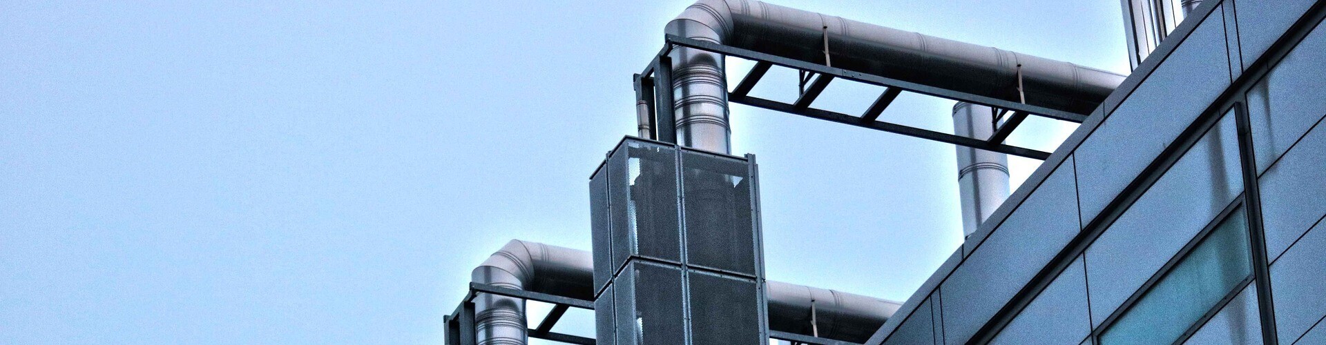 Industrial pipes coming out of a building