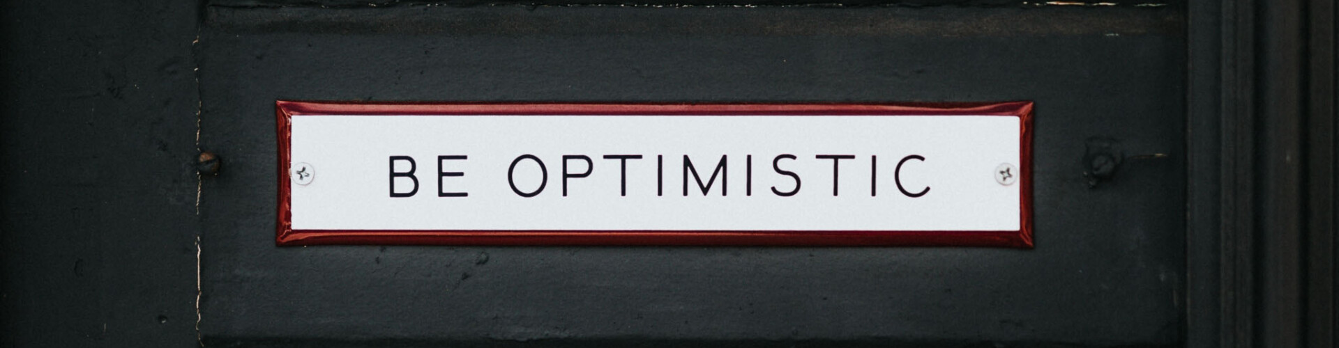 Bordje met daarop 'Be optimistic'
