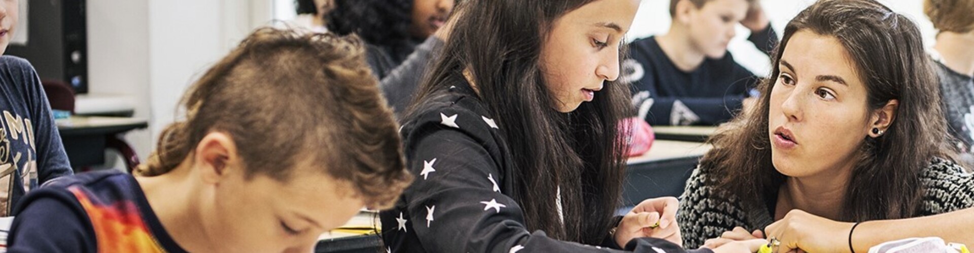 A teacher helping a child learn how to read