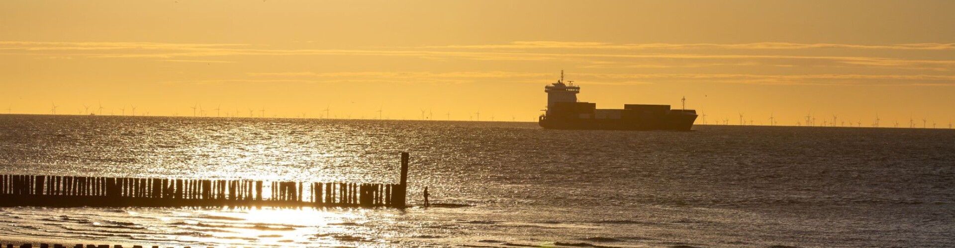 A boat on the Westerschelde with a beach in the front