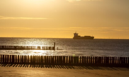 A boat on the Westerschelde with a beach in the front