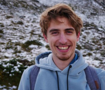 Lars next to a snowy mountain