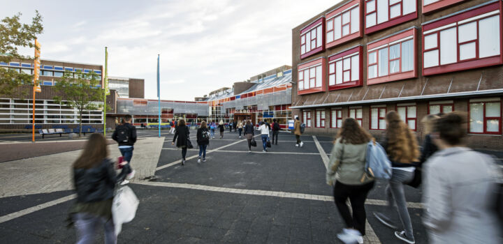 Outside of the HZ building in Vlissingen with students walking towards the entrance