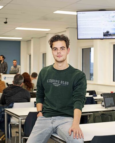 River Delta Development student leaning against a desk in a classroom