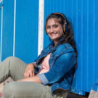 Aadya poses in front of a beach hut