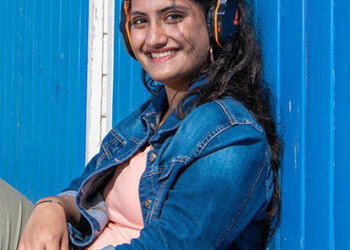 Aadya poses in front of a beach hut