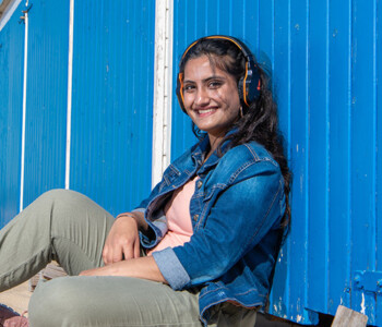 Aadya poses in front of a beach hut