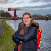 Picture of Michelle in front of the canal with a bridge in the background