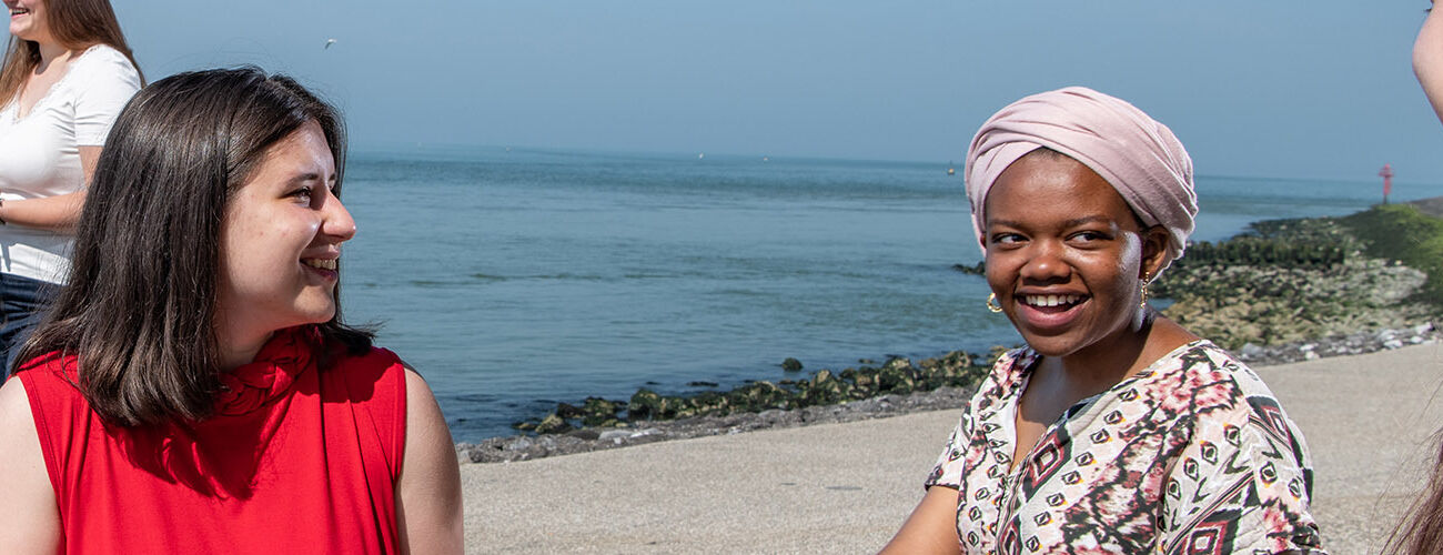 International female students, who are studying at HZ, talking in English together at the beach in Vlissingen, Zeeland, The Netherlands