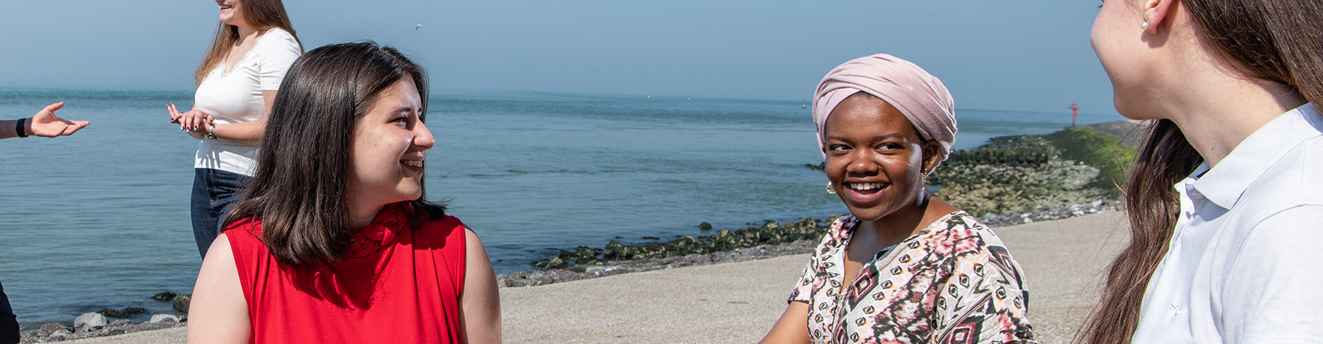 International female students, who are studying at HZ, talking in English together at the beach in Vlissingen, Zeeland, The Netherlands