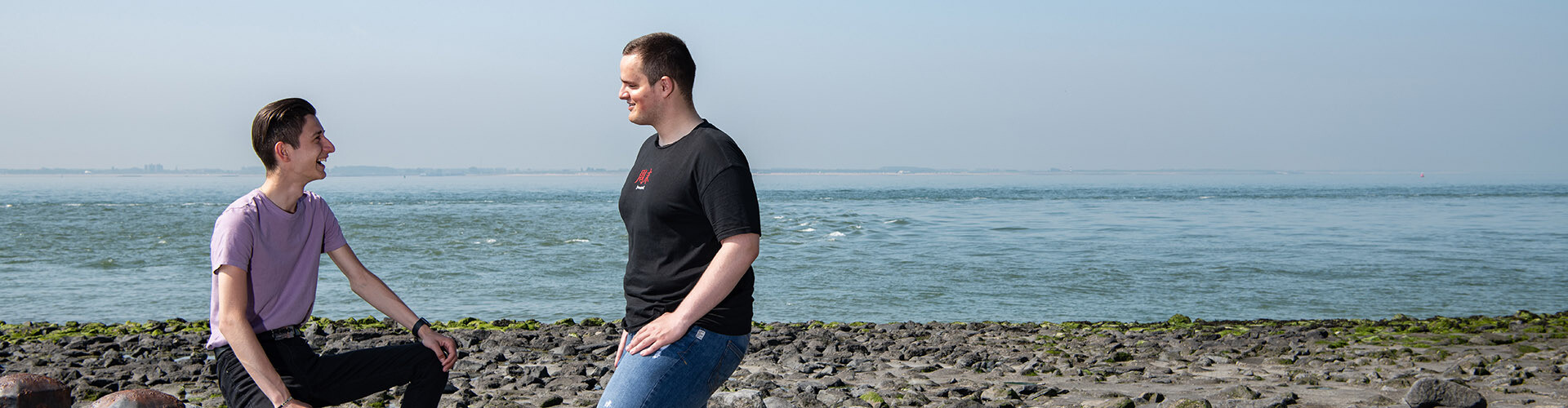 Two international IT students of HZ University of Applied Sciences standing on the beach in Vlissingen, Zeeland, The Netherlands