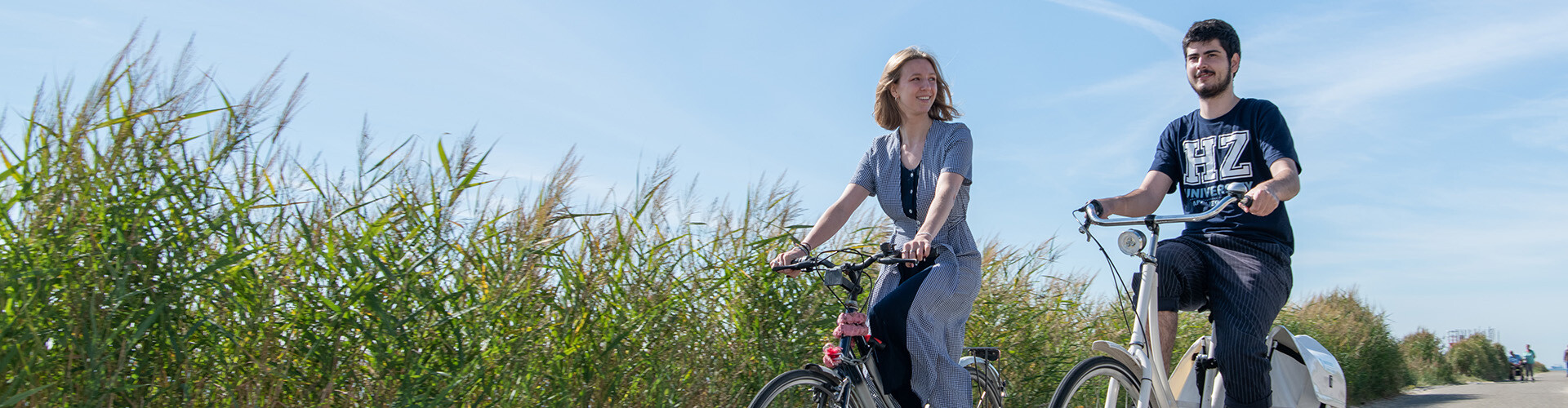 Two international students riding their bike at sea side in Vlissingen, The Netherlands.