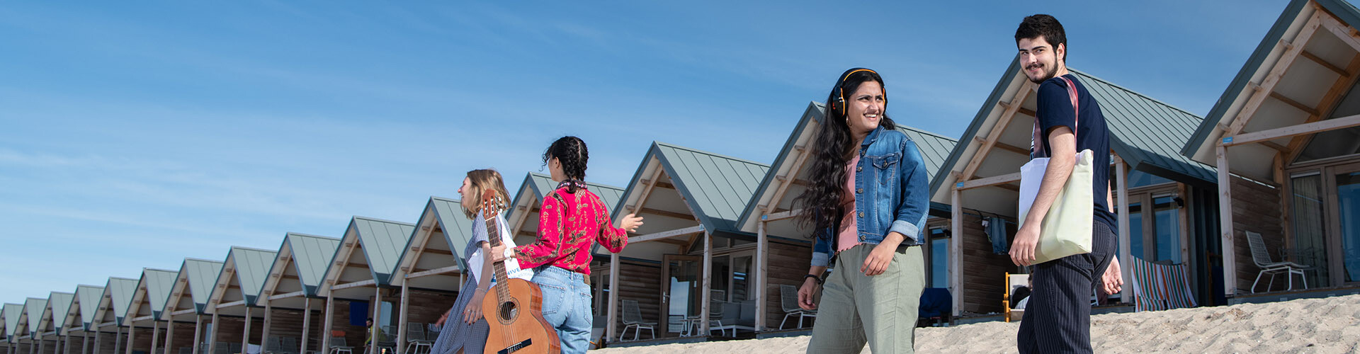 A group of international students walking at the beach to go work on a group assignment for their English taught study programma at HZ University of Applied Sciences, Vlissingen, The Netherlands.