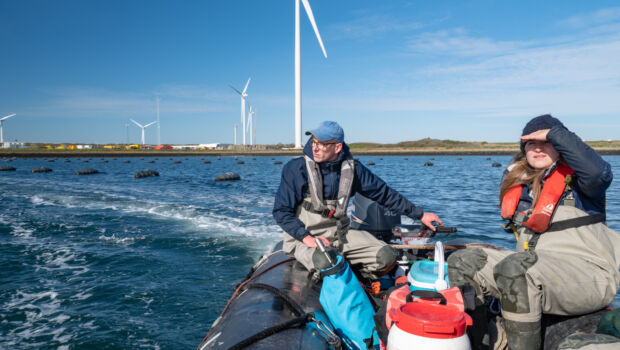 A female student and a male student on an boat excursion on the coastal area of Zeeland, The Netherlands