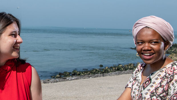 International female students, who are studying at HZ, talking in English together at the beach in Vlissingen, Zeeland, The Netherlands