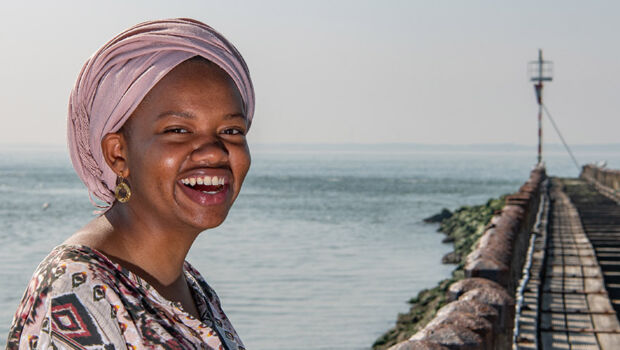 International student smiling with perfect white teeth at the peer in Vlissingen, the Netherlands.