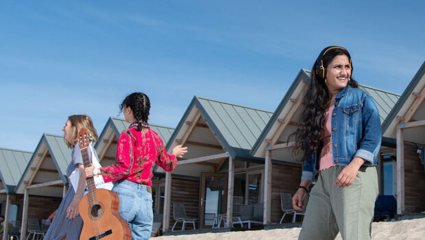 A group of international students walking at the beach to go work on a group assignment for their English taught study programma at HZ University of Applied Sciences, Vlissingen, The Netherlands.